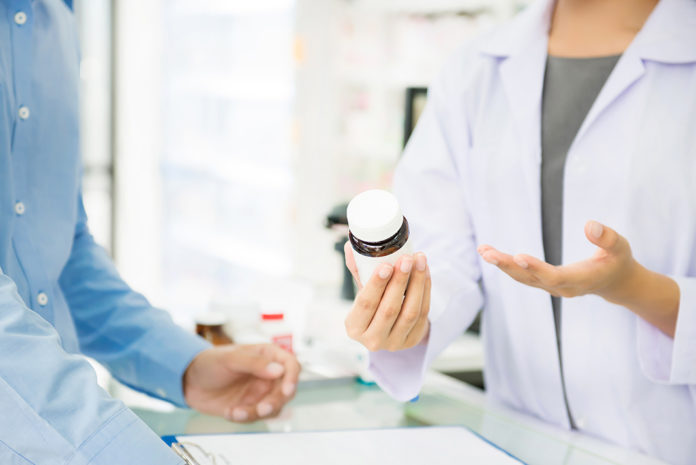 Pharmacist counseling customer Pharmacist counseling a customer